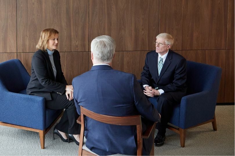 Three public finance bankers conducting a meeting.